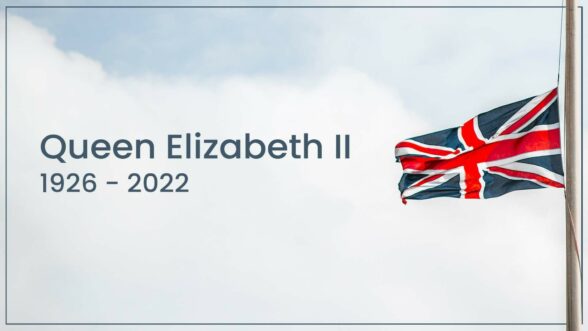 Image of a British flag at half mast in the sky with the text "Queen Elizabeth II 1926 - 2022"