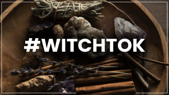 Image of crystals, sage, and other witchy paraphernalia on a wooden bowl with the text "#Witchtok" overlaid