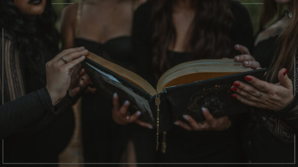 Image of a group of witches standing in the woods while holding a book
