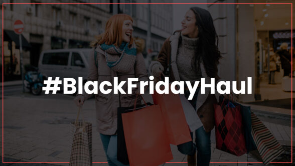 Image of two women smiling and walking across the street holding shopping bags with the text #BlackFridayHaul overlayed.